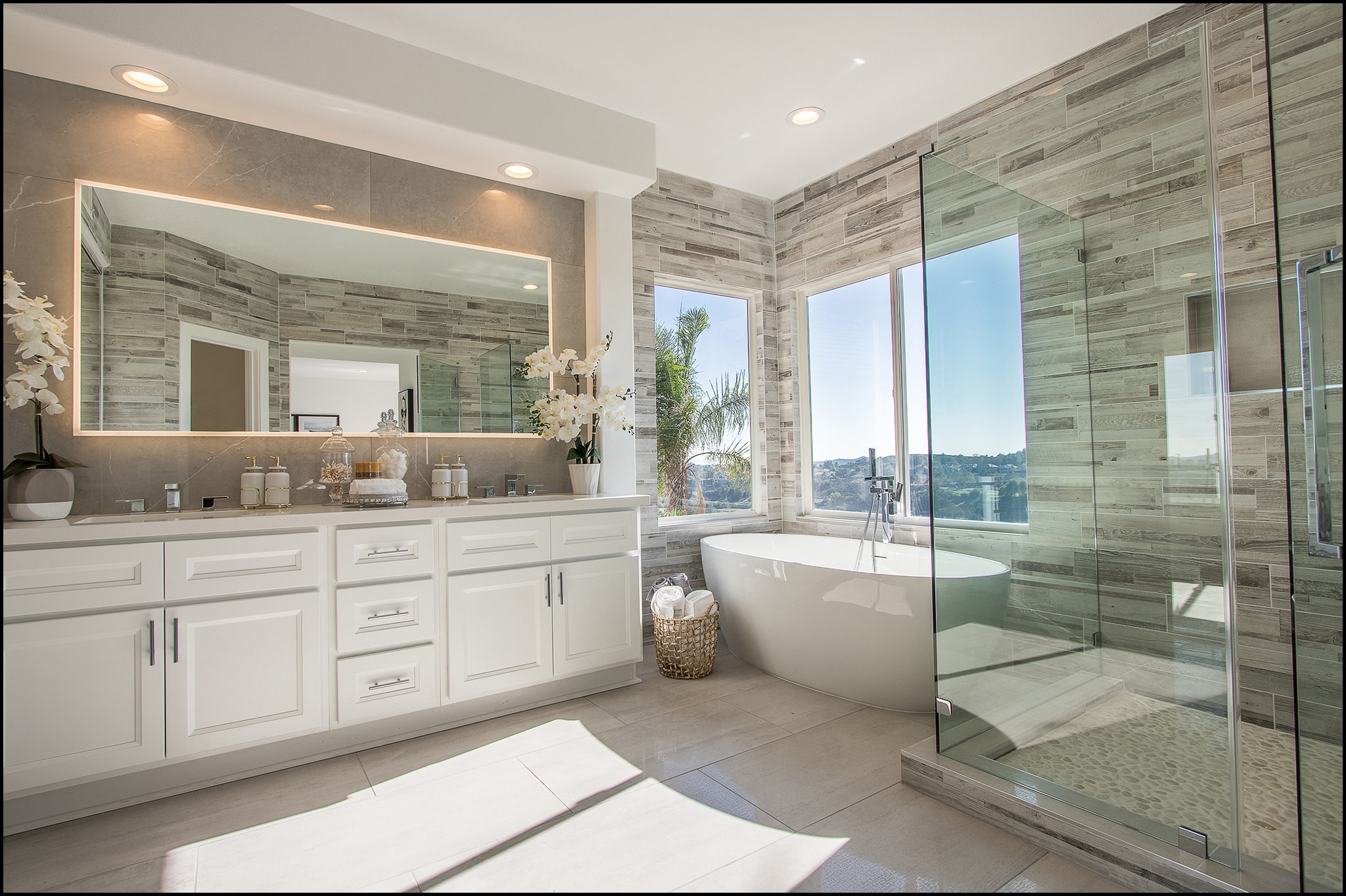 Bathroom remodel in Irvine CA — floating vanity with backlit mirror, vessel sink, and contemporary tile flooring by Main Street Kitchen & Flooring