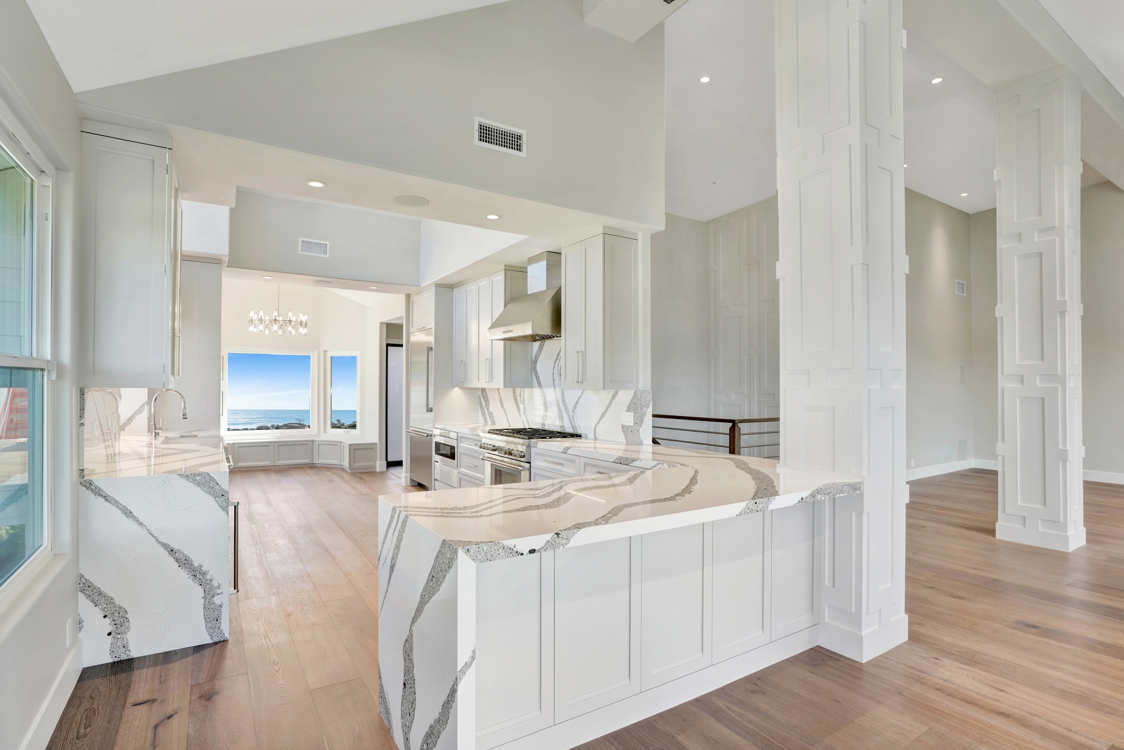 Laguna Beach kitchen remodel with white shaker cabinets and quartz island by Main Street Kitchen & Flooring
